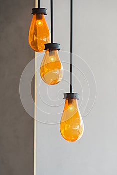 Modern beautiful set of orange color of ceiling lamp light bulbs and white wall interior for office building or home and living