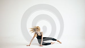 Modern beautiful teenage girl dancer dancing contemporary on white background indoors