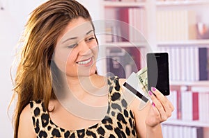 Modern beautiful young woman holding cell phone