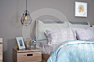 In a modern bedroom bed, pillows and bedside lamps