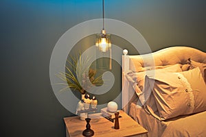 In a modern bedroom bed, pillows and bedside lamps