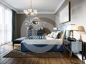 A modern bedroom in an eclectic style. With a double blue bed, black dressing table and chest of drawers with decor. beige walls