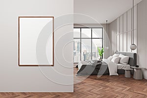 Modern bedroom interior with a blank white poster on the wall, wooden flooring, and city view background, concept of home decor.