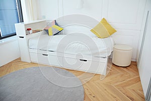 Modern bedroom interior design with luxury white child bed, contemporary interior design and cozy carpet.