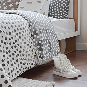 Modern bedroom interior with girl sneaker on wooden floor and po