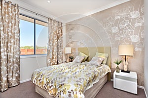 Modern bedroom with a master bed and light brown color curtain d