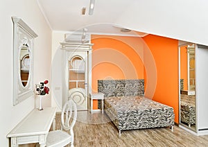 Modern bedroom in orange with zebra patterned bed