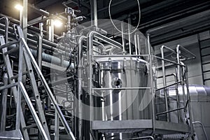Modern beer factory, brewery. Steel tanks and pipes for beer production. Industrial background