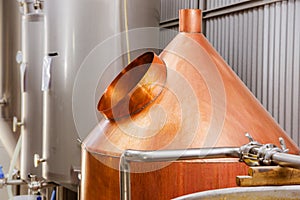 Modern beer plant brewery , with brewing kettles, vessels, tubs and pipes made of stainless steel, in a beer plant in