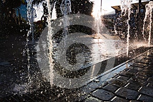 Modern and beutifull waterfall with sun in the back. Water drops dancing