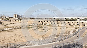 Modern Bike Path and Ancient Ottoman Train Bridge in Beer Sheva in Israel in Front of a Modern Train Bridge