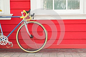 Modern bike stand near wooden wall