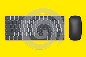 Modern black aluminum computer keyboard and mouse isolated on yellow background.