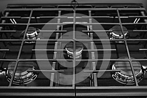 Modern built-in gas cooktop. Gas oven hob with gas burners and grate kitchen stove. Black Gas cooker