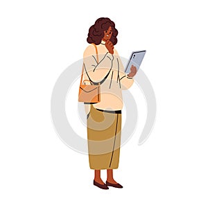 Modern black businesswoman looking at tablet PC in hand. Business woman using technology, device in work. Female