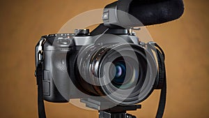 Modern black digital DSLR camera with microphones