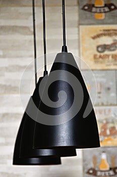 Modern black domes hanging from the ceiling illuminating and decorating the kitchen photo