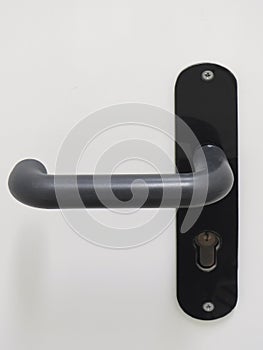 Modern black door handle on white background. Architecture detail. Front view