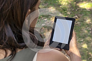 A modern black electronic book with a white blank empty screen. E-Book Reader and book mock up