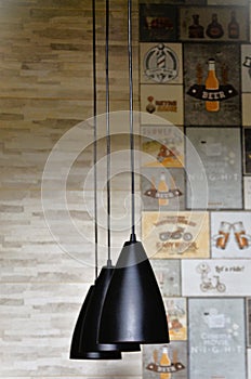 Modern black lamps hanging from the ceiling decorating kitchen