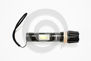 Modern black metal flashlight isolated on white background