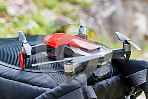Modern black and red drone for taking pictures in nature close