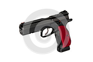 A modern black semi-automatic pistol with a red grip. A short-barreled weapon for self-defense and sport. Isolate on a white back