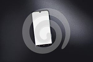 Modern black smart phone isolated on dark background in perspective view. New smartphone mockup with blank touch screen.