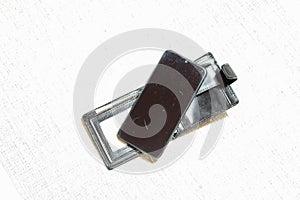 A modern black smartphone is on the wallet