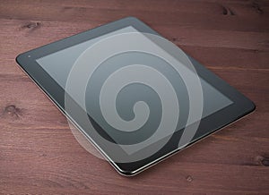 Modern black tablet pc on old wood table