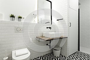 Modern black and white tiled floor cloakroom with white porcelain