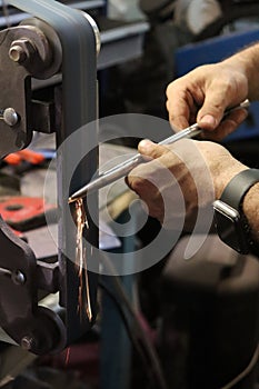 Modern blacksmith working in his shop