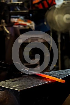 Modern blacksmith working in his shop