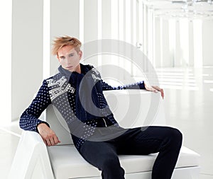 Modern blond male futuristic sci-fi sitting photo