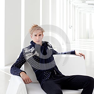 Modern blond male futuristic sci-fi sitting photo