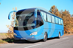 Modern blue bus on road