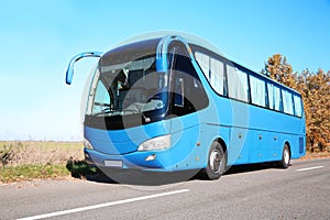 Modern blue bus on road.