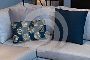 Modern blue fabric pillows and checkered pattern on the cushion gray sofa