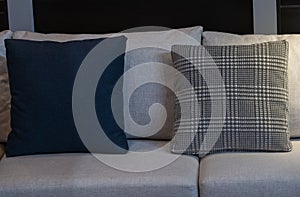 Modern blue fabric pillows and checkered pattern on the cushion gray sofa interior