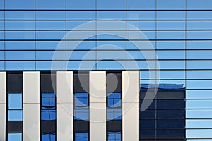 Modern blue glass facade of an office skyscraper. Abstract architecture background.