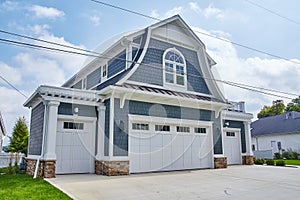 Modern Blue Shingle House with White Trim and Stone Accents