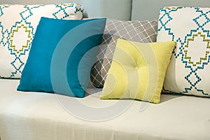 Modern blue, yellow, brown, beige colorful pillows and cushion on fabric sofa interior for office building or home and living