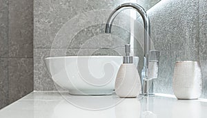 Modern bowl-shaped washbasin with chrome water mixer