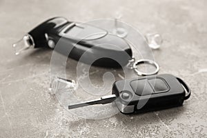 Modern breathalyzer and car key on brown marble table