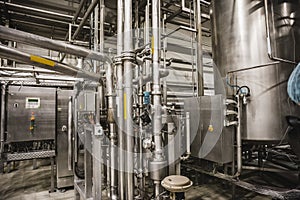 Modern brewery factory interior.Steel tanks or vats for filtration beer, pipe lines and other equipment tool in plant workshop