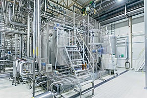 Modern brewery interior. Filtration vats, pipeline, valves and other equipment of beer production line