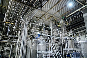 Modern brewery interior. Vats, pipes and other equipment of beer production line