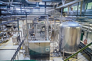 Modern brewery production line. Large vat for beer fermentation and maturation, pipelines and filtration system