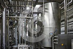 Modern brewery, steel vats or tanks and stainless steel pipes, equipment machinery tools for beer production