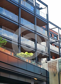 Modern brick, glass and steel facade of the residential building with balconies